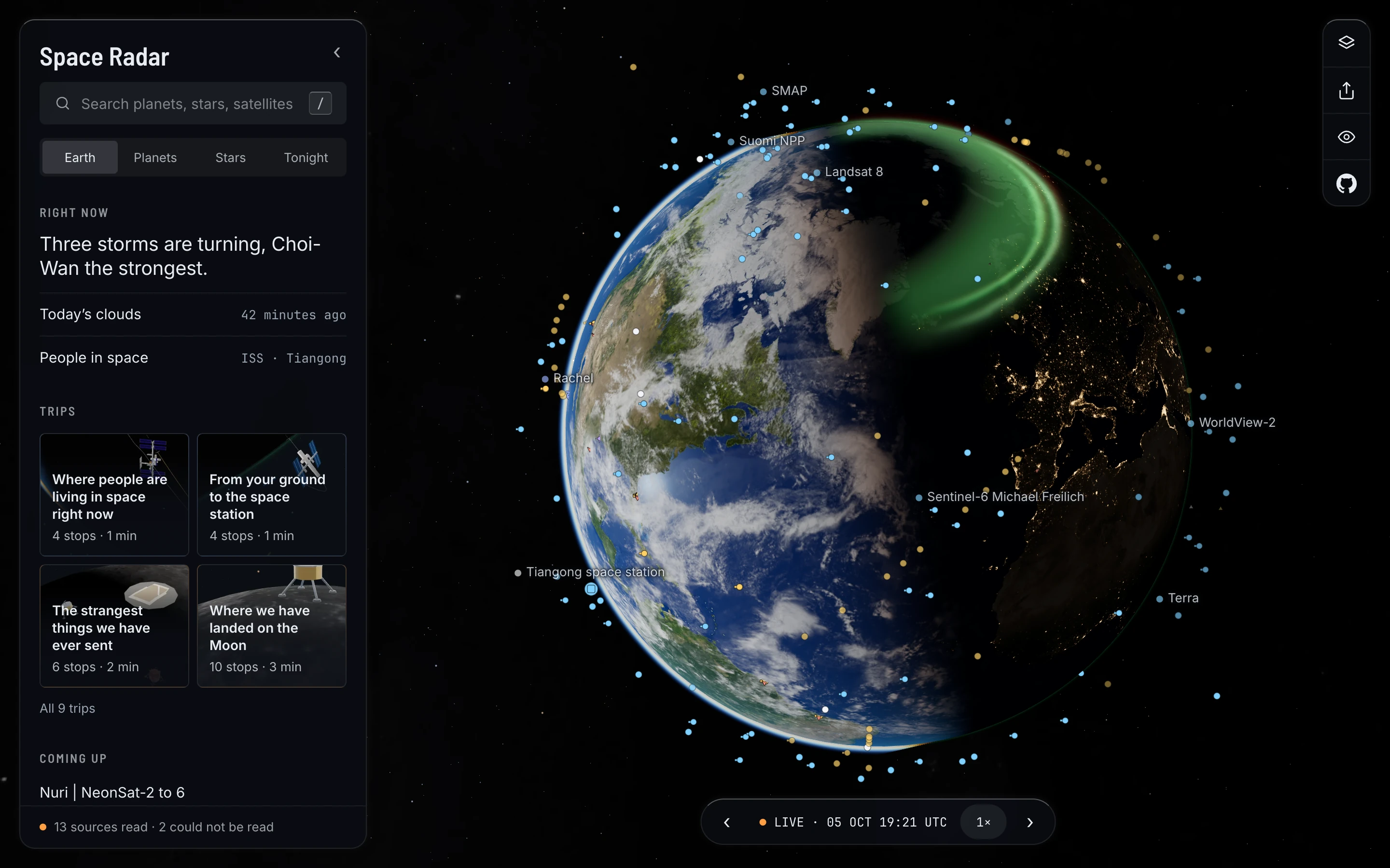 The Earth with today's clouds, the aurora and the satellites around it.