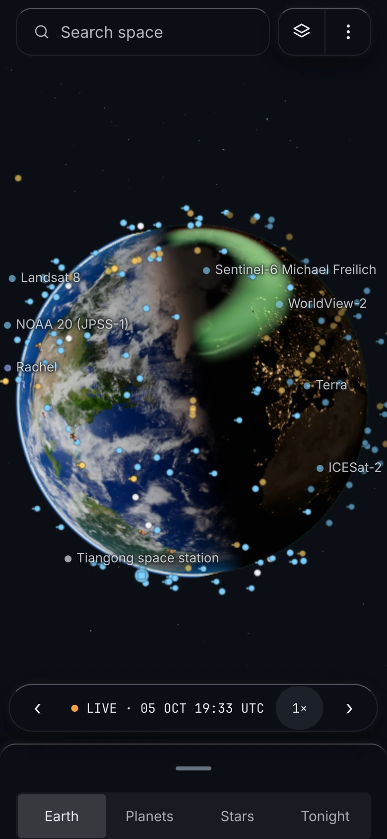 On a phone: the Earth, the aurora and the satellites above a bottom sheet.